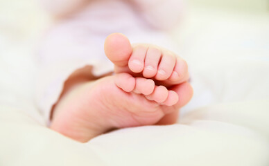 Children's legs close-up. Small feet with tiny toes. Newborn baby. Great childhood. Healthy lifestyle.
