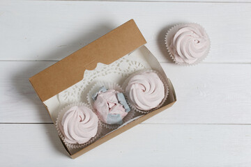 Homemade marshmallows in a cardboard box. Zephyr flowers. Gift wrap.