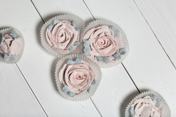 Homemade marshmallows. Zephyr flowers. On white boards.