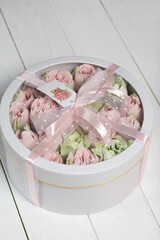 Homemade marshmallows in a cardboard box. Zephyr flowers. Box with transparent lid. Gift wrap. Tied...