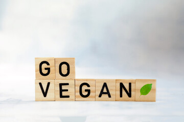 Go vegan text with fresh with green leaf on wooden cubes. Veganism, vegetarian,health,green,eco...