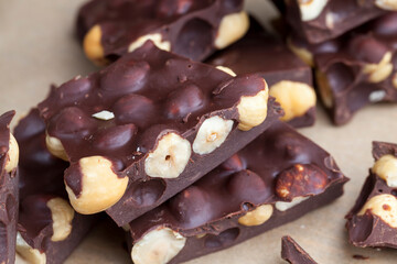 Pieces of homemade milk chocolate with lots of hazelnuts