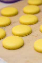 Obraz na płótnie Canvas yellow halves for macaroons cookies on the table. home bakery concept.