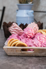 handmade fruit marshmallows and cookies in a wooden tray on the table. home bakery concept.