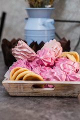 handmade fruit marshmallows and cookies in a wooden tray on the table. home bakery concept.