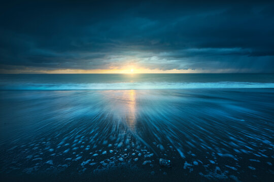 Sea at sunset after the thunderstorm. Marina di Cecina beach, Tuscany, Italy.