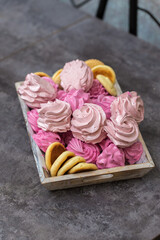 handmade fruit marshmallows and cookies in a wooden tray on the table. home bakery concept.