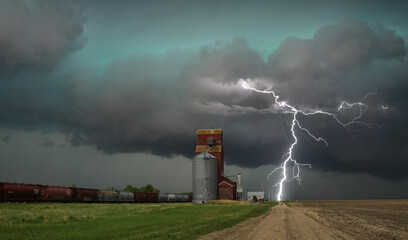 Lightning beside a grain elevator