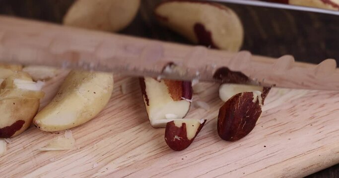 Cut into pieces fresh dry Brazil nuts without shells, preparation and grinding of Brazil nuts in the kitchen