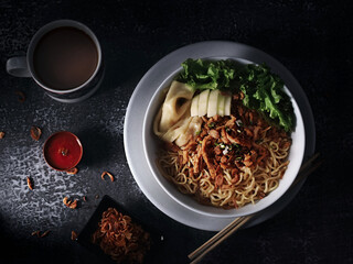 chicken noodles, indonesian ramen with chicken noodle soup, vegetable and dumpling in dark background