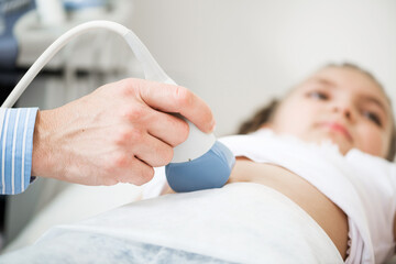 Medical exam little girl by ultrasound equipment