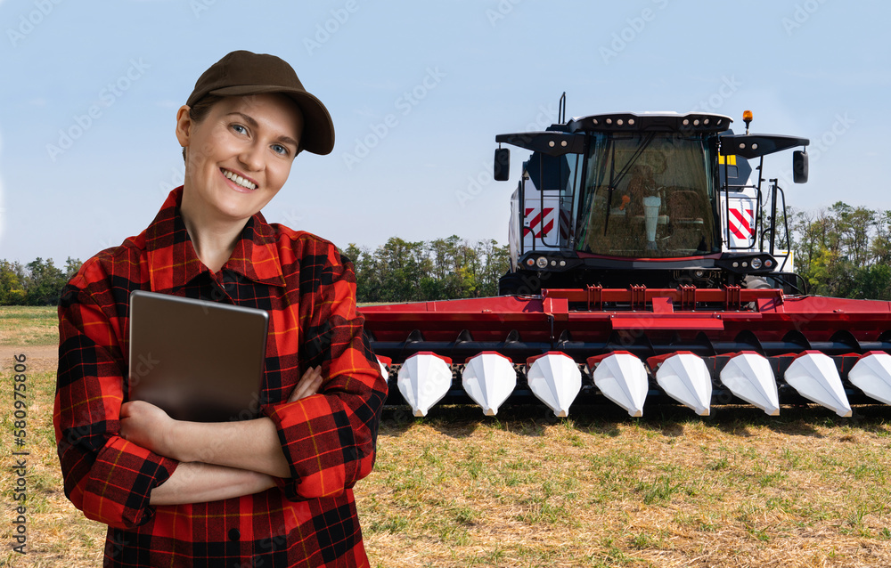 Poster farmer with digital tablet on a background of combine harvester. smart farming concept.