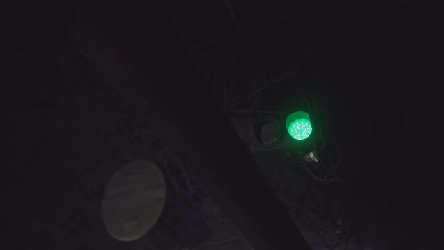 Bright red light turns to green letting vehicle go in mine