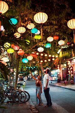 Backpacker couple enjoy trip through Southeast Asia while visiting Hoi An city, Vietnam