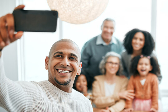 Group, happy and a man with family for a selfie, memory and photo together. Smile, bonding and a guy taking a picture on a phone with parents and children for quality time during a home visit