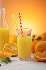 Oranges and orange juice in glasses	