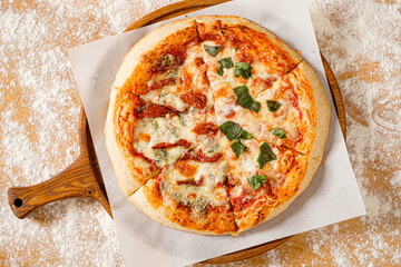 homemade italian pizza on the wooden board