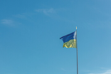 Ukrainian flag against the blue sky