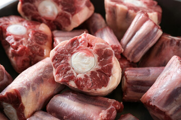 Raw pieces of oxtail with bone, gelatin-rich meat, usually slow-cooked as a stew or braised,...