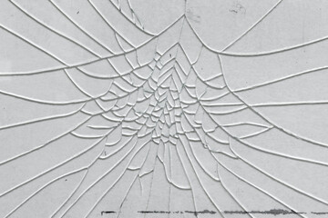 Cracks on broken shattered window glass