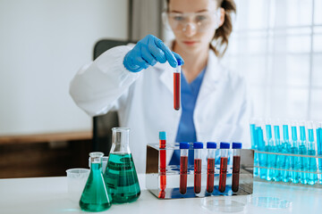 Female biotechnologist testing new chemical substances in laboratory.