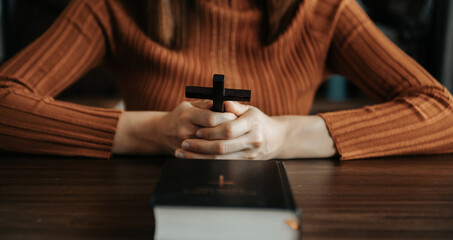 Fototapeta na wymiar Woman praying on holy bible in the morning.Woman hand with Bible praying. Christian life crisis prayer