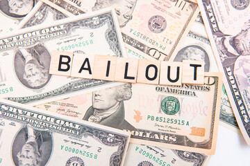 bailout inscription next to american dollars. Saving failing banks. Financial crisis concept