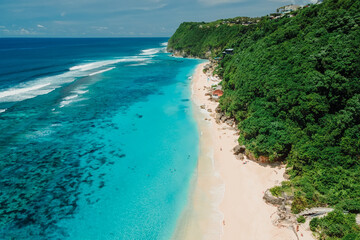 Paradise tropical beach with turquoise ocean in Bali. Aerial view