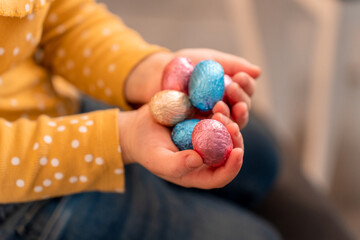 toddler holding a chocolate eggs