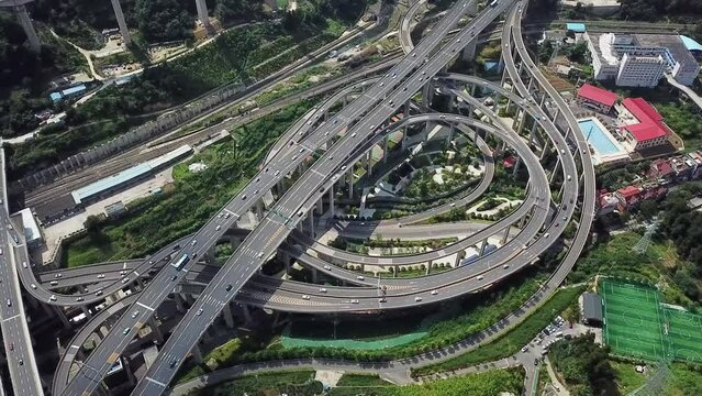 spinning aerial shot of the highway intersection and freeway bridges of Chongqing, Huangjuewan, China, daytime.