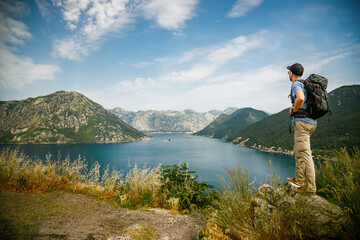 Tourist man enjoying amazing sea view of the Bay of Kotor, Montenegro