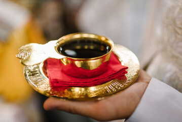 Wedding bowl in the church in the priest's hand. Golden cup of blood. A chalice of communion wine....
