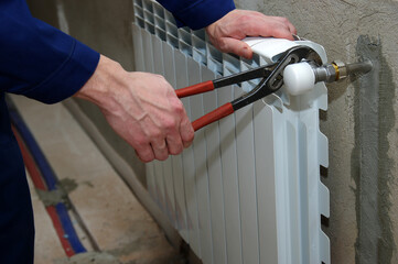 Plumber fixing a radiator