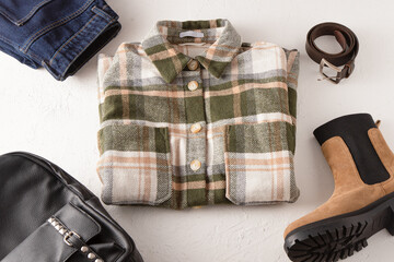 Set of clothes. Checked shirt, jeans, beige boots, leather backpack. Shoes and wardrobe. Women's modern style. Clothing top view. Woman clothes and accessories casual spring winter autumn outfit.