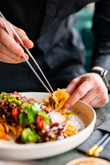 chef hands decorated food on plate
