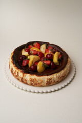 Cheesecake with fresh fruits on white background
