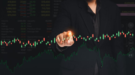 Stock exchange market analysis. A businessman or trader pointing to a graph stock on a virtual screen