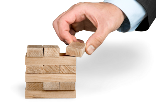 Businessman Building a Tower of Wood Blocks - Powered by Adobe