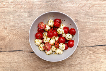 A simple salad with mozzarella cheese and cherry tomato with balsamic dressing.