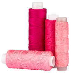 Spools with red and pink thread for sewing, craft supply, isolated cut out object on transparent or...