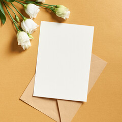 Invitation or greeting card mockup with envelope and white eustoma flowers