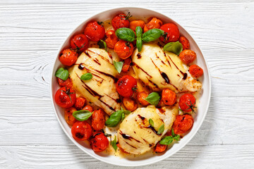 caprese chicken in white baking dish, top view