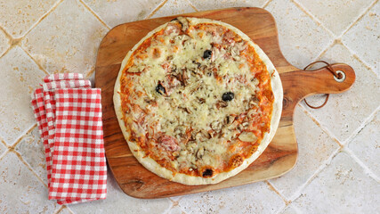 pizza industrielle au jambon et champignons sur une table © ALF photo