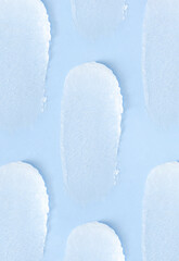 cosmetic smears scrub cream texture on pastel blue background