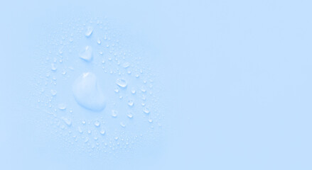 water drops of transparent gel serum on a pastel background