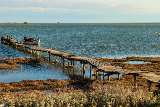 view of fishing boats from an abandoned wooden pier by the seaside