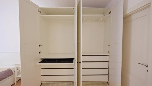 Zoom out revealing an empty clothes closet in a new apartment