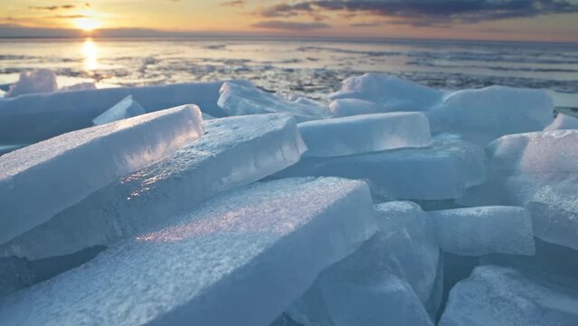 Melting ice in spring. Crashed ice in the rays of the setting sun. Blue ice on the ocean. Global warming and climate change concept ice nature concept. Slider 4K shot