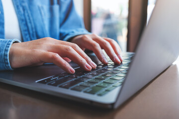 Closeup image of a woman working and typing on laptop computer keyboard - obrazy, fototapety, plakaty
