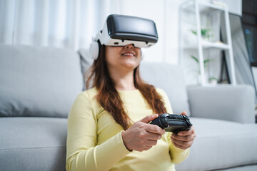 Young Asian woman gamer wearing virtual reality touching air during the VR experience  Future home technology player hobby playful enjoyment concept.